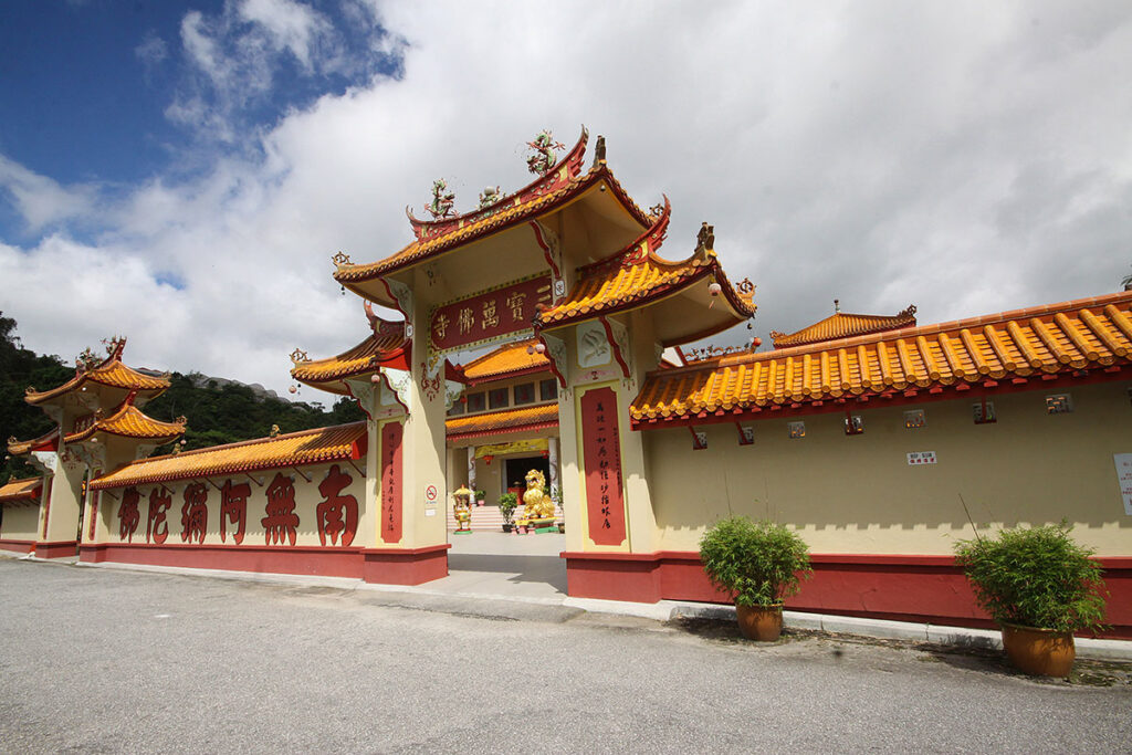 Ornate orange-roofed Sam Poh Buddhist temple with red Chinese lettering in Brinchang