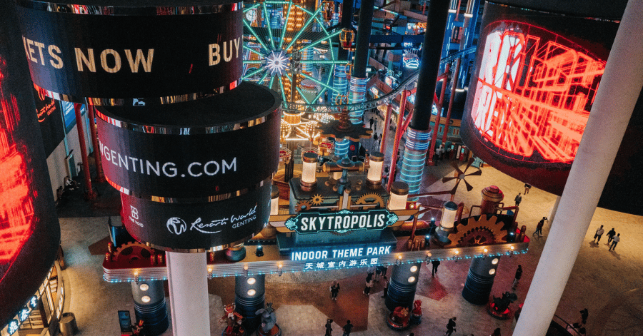 Neon-lit Skytropolis and SkyAvenue interior busy with visitors at night