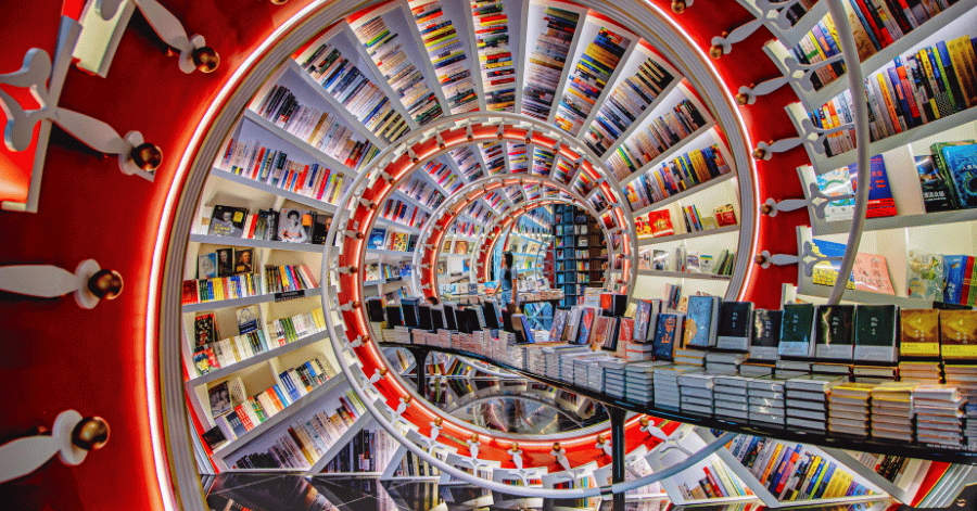 Mirrored red spiral tunnel of bookshelves inside Shenzhen's Zhongshuge bookstore