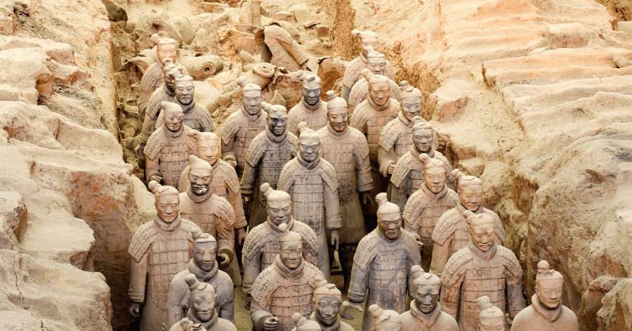 A group of Terracotta Army warriors standing in an excavation pit