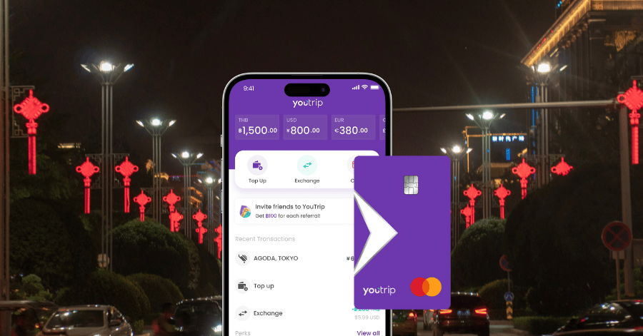 The YouTrip app and Mastercard card against a lantern-lit Xi'an street at night