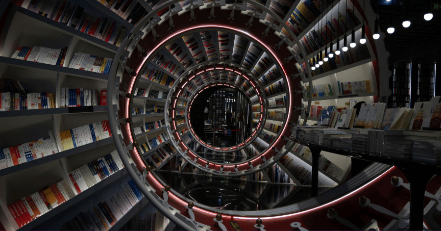 Dramatic spiral tunnel of bookshelves curving into the distance in a Shenzhen bookstore