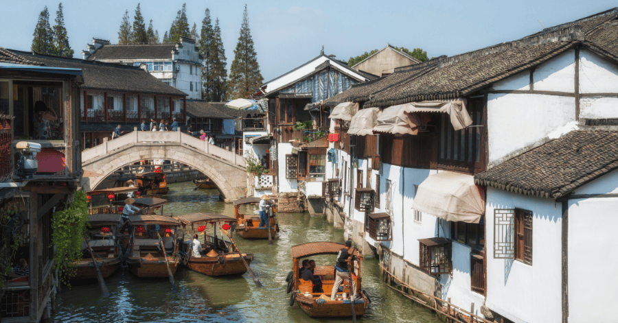 Tour boats and an arched stone bridge on a Zhujiajiao canal