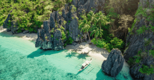Turquoise hidden lagoon ringed by limestone karst cliffs with an outrigger boat, Palawan, Philippines