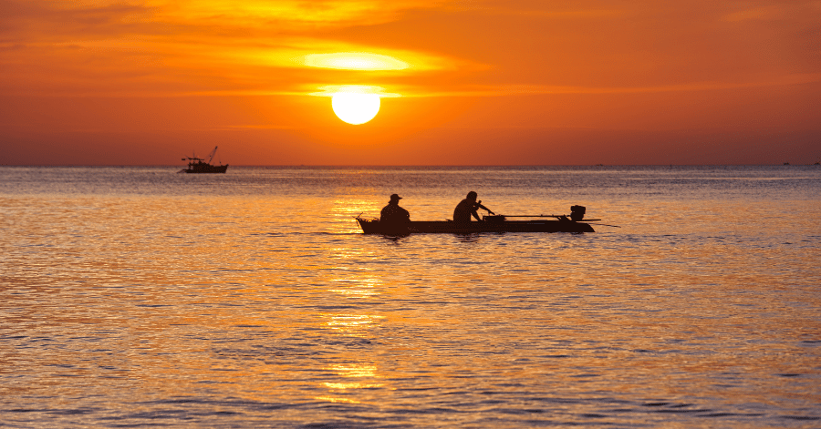 Silhouette of a small fishing boat on the sea at sunset off Phu Quoc