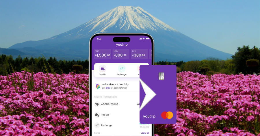 YouTrip app on a phone in front of Mount Fuji and a pink flower field