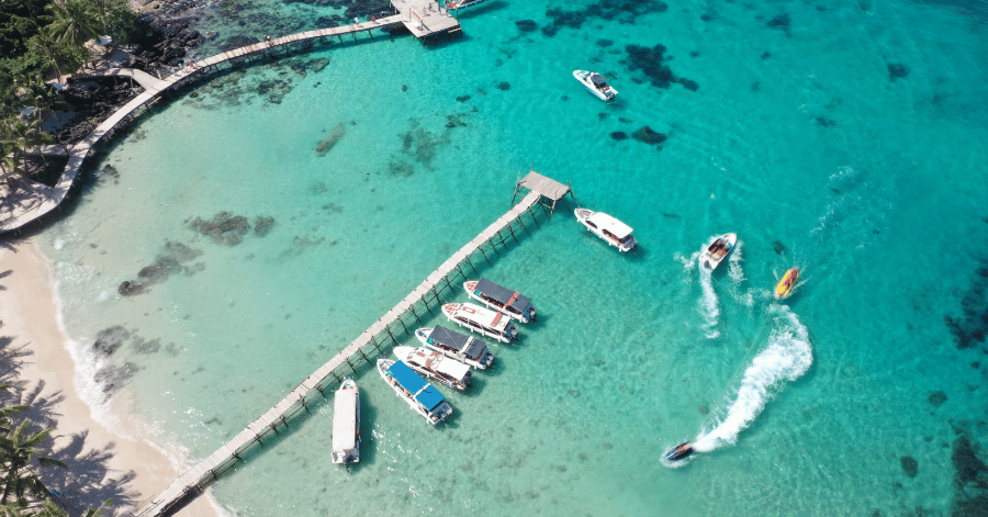 Aerial view of boats moored at a jetty in Phu Quoc's clear turquoise shallows