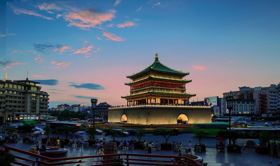 Xi'an's Bell Tower lit up at dusk above the city-centre roundabout
