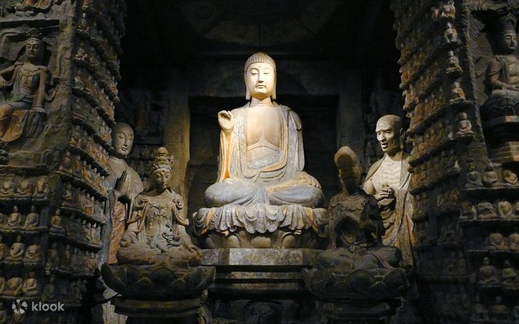 A carved stone Buddha statue with attendant figures at the Shaanxi History Museum