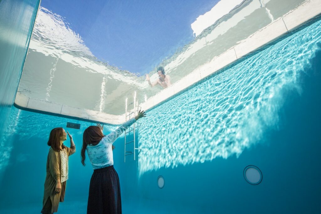 Visitors viewing Leandro Erlich's Swimming Pool illusion at the 21st Century Museum, Kanazawa