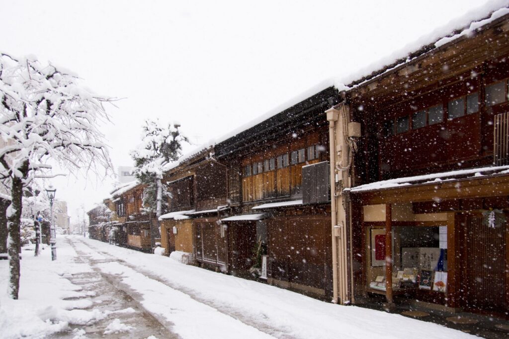 Snow falling on a street of wooden teahouses in Kanazawa's Nishi Chaya district