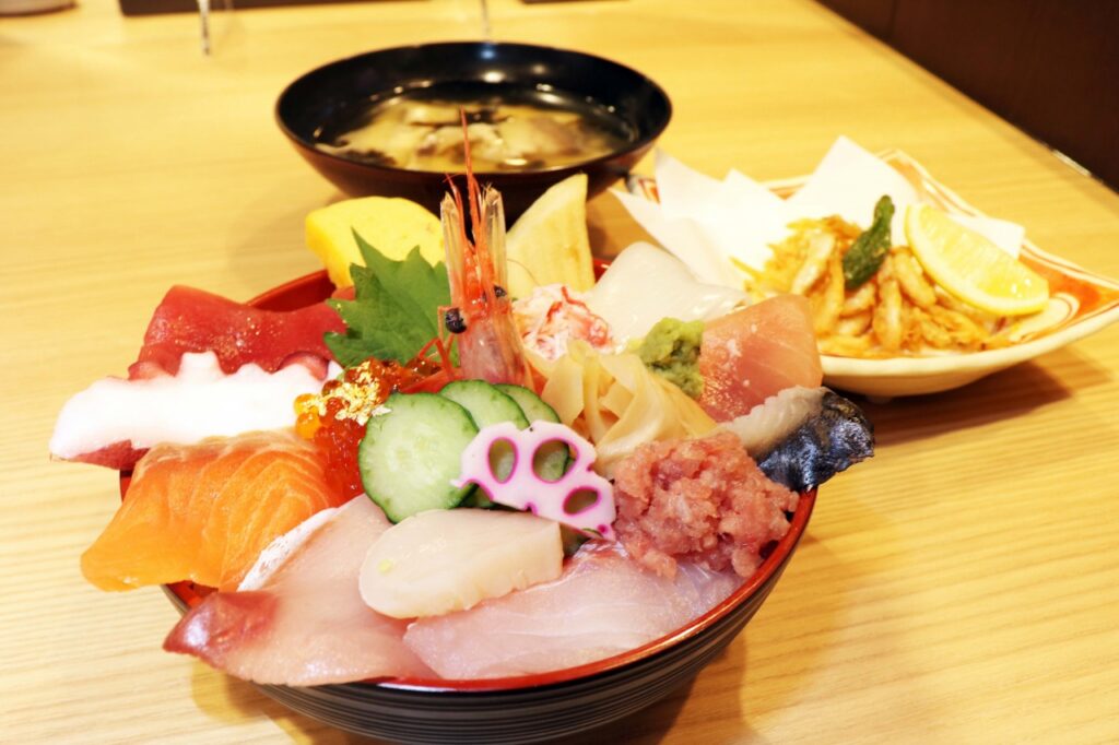 A kaisendon rice bowl piled with fresh sashimi, with miso soup on the side