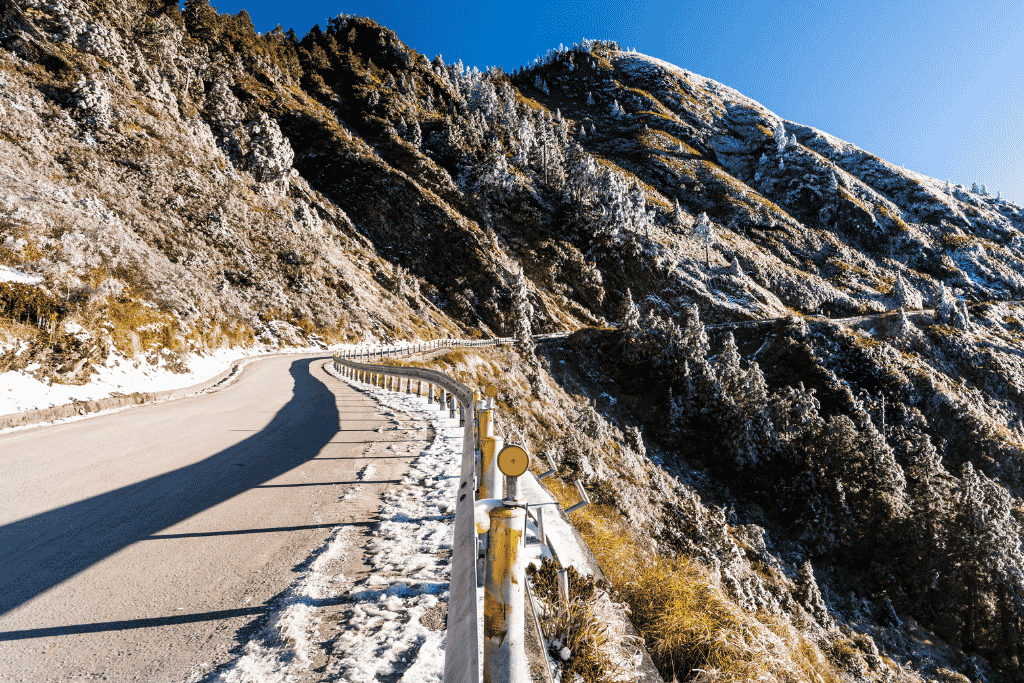 Snow and frost along a winding high mountain road at Hehuanshan in central Taiwan