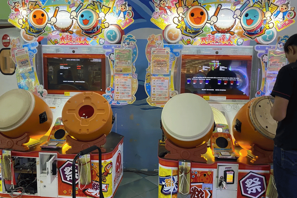 Two Taiko no Tatsujin drum arcade machines at an indoor games arcade