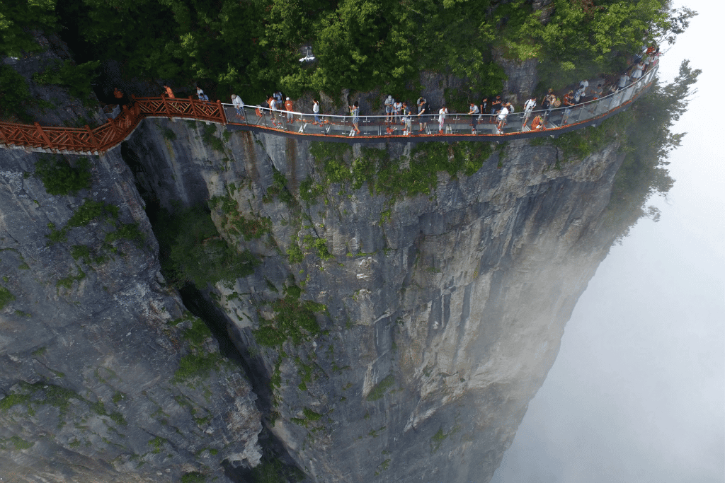 The Coiling Dragon Cliff skywalk clinging to a sheer Tianmen Mountain cliff above cloud