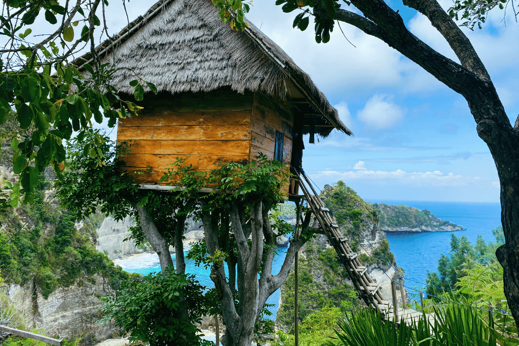A thatched clifftop tree house cabin on stilts overlooking the sea on Nusa Penida