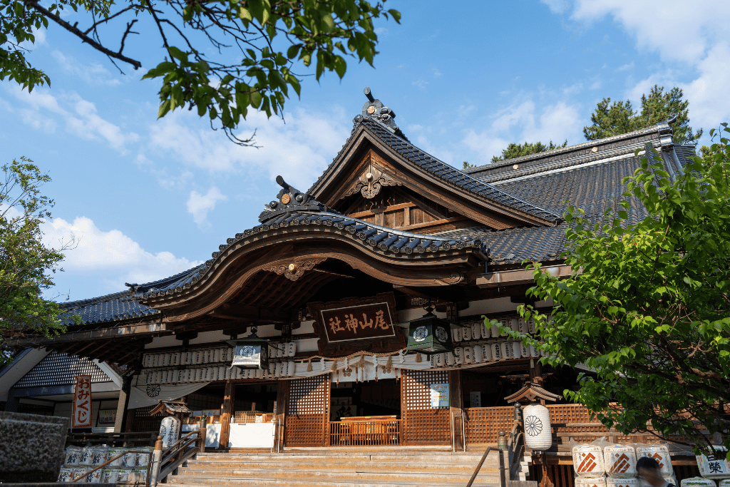 The wooden main worship hall of Oyama Shrine in Kanazawa, hung with lanterns