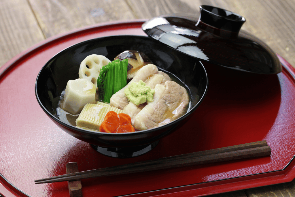 A lacquer bowl of jibuni, Kanazawa's duck stew, topped with wasabi and vegetables
