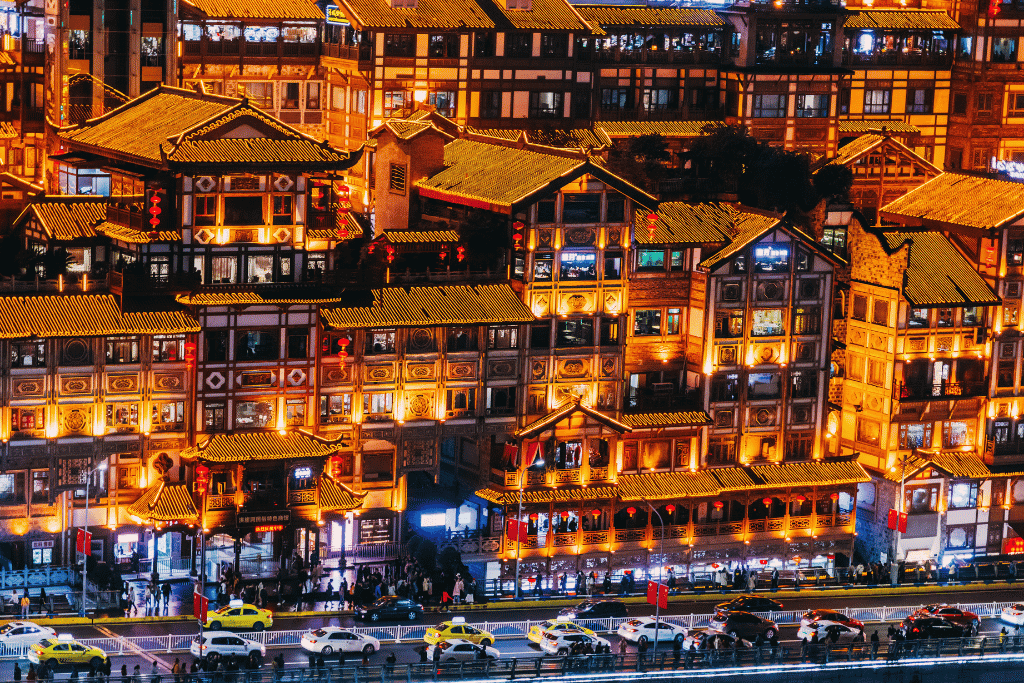 Hongyadong's traditional stilt buildings glowing gold at night, Chongqing