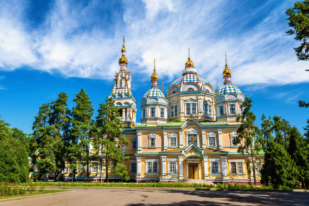The candy-coloured wooden Ascension Cathedral with golden domes in Panfilov Park