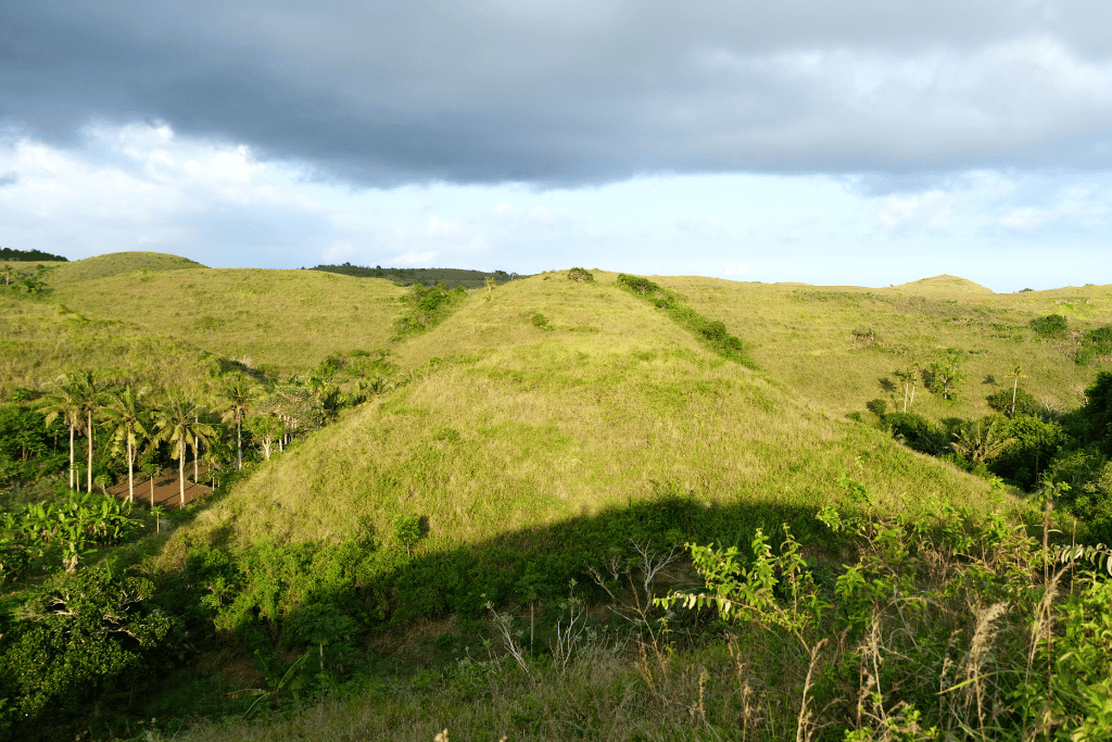 The rolling green mounds of Teletubbies Hills under a cloudy sky, Nusa Penida