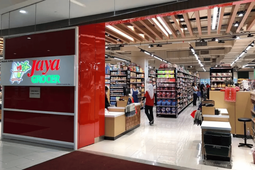 Entrance to the Jaya Grocer supermarket inside R&F Mall, with grocery aisles and shoppers
