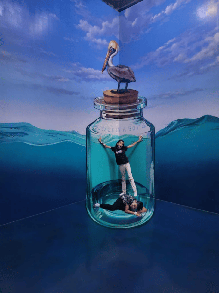 Visitor posing inside a giant message-in-a-bottle mural at 3D Art in Paradise, Langkawi