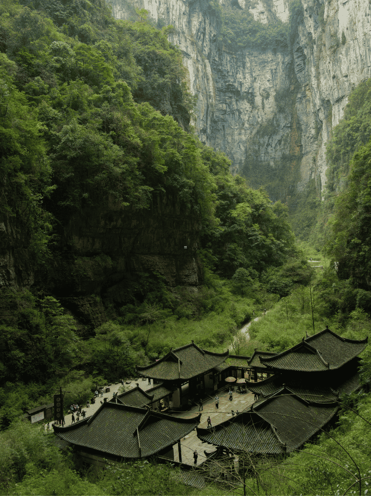 Sheer karst cliffs above a traditional courtyard at Wulong, Chongqing