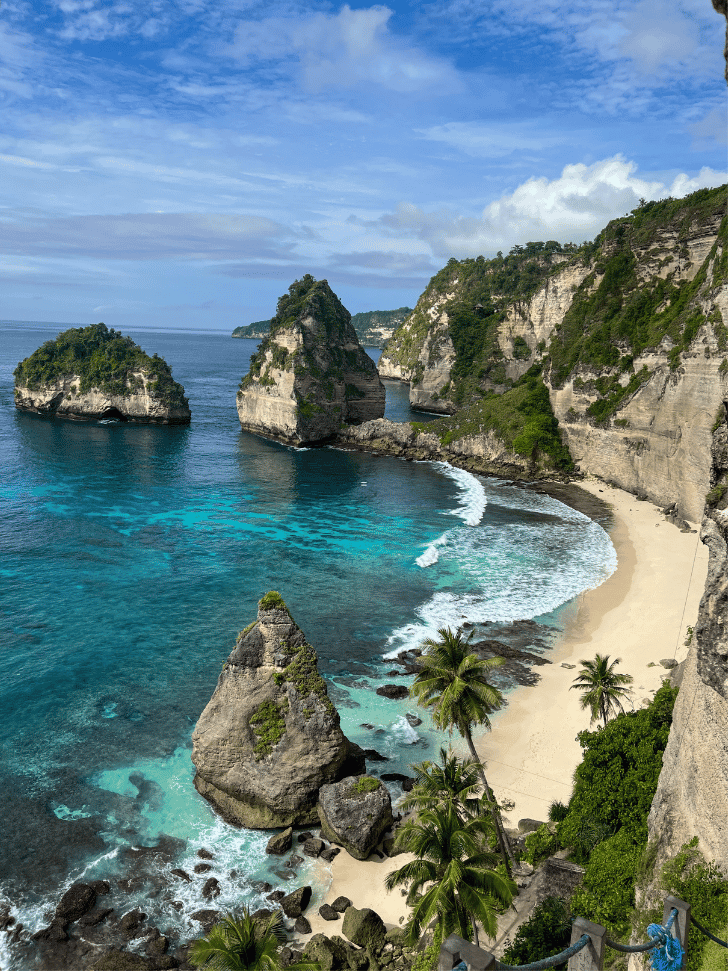 Diamond Beach's curved white sand, turquoise shallows and limestone sea stacks from the cliff