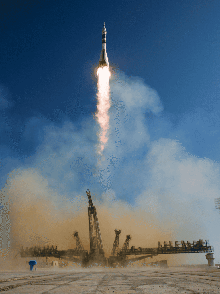 A rocket lifting off in flame and smoke from Baikonur Cosmodrome