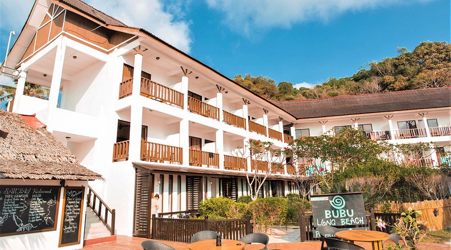 White multi-storey BuBu Long Beach Resort with wooden balconies and a beachfront restaurant deck on Perhentian Kecil
