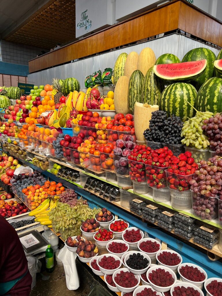 Colourful fruit and berry stall piled high at Almaty's Green Bazaar