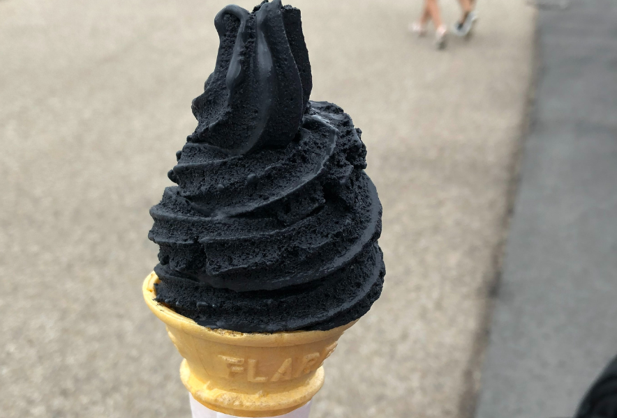 A swirl of jet-black bamboo-charcoal soft-serve ice cream in a cone