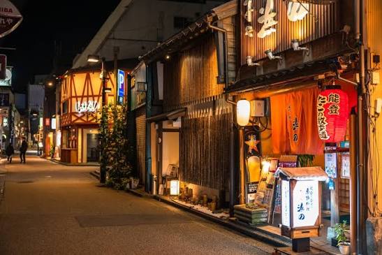 A lantern-lit izakaya frontage on a quiet Kanazawa street after dark