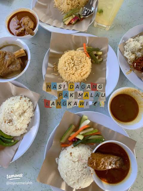 Plates of nasi dagang with fish curry and sides at Nasi Dagang Pak Malau, Langkawi