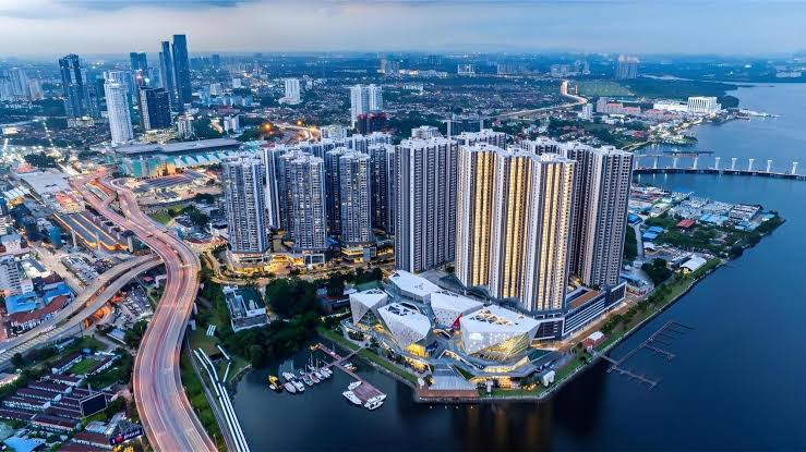 Aerial view of R&F Princess Cove's condo towers and mall on the Johor Bahru waterfront at dusk