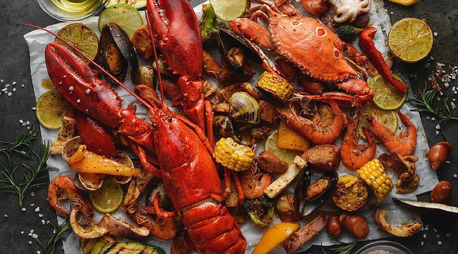 Overhead spread of grilled lobster, crab, prawns, mussels and corn, Langkawi seafood