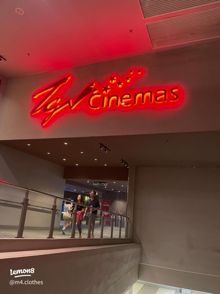 The glowing red TGV Cinemas sign above the cinema entrance and walkway
