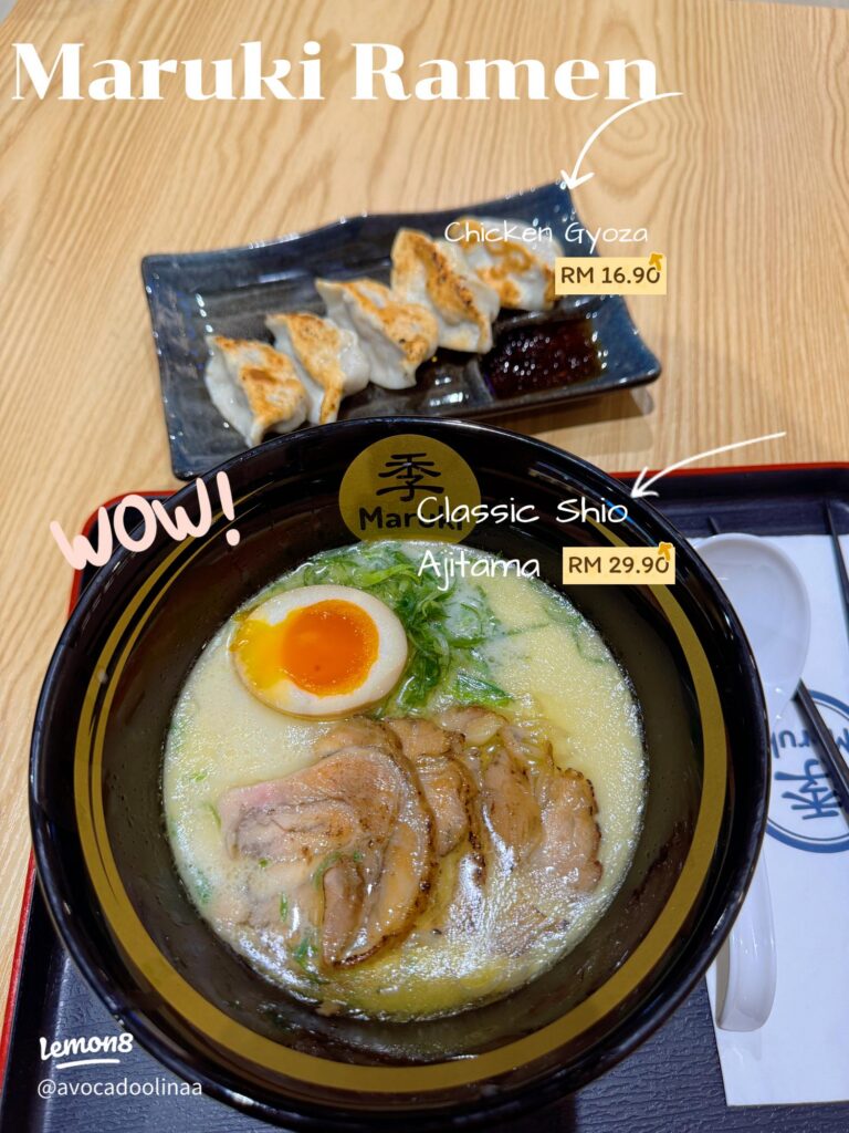 Bowl of creamy shio ramen with chashu and egg beside a plate of chicken gyoza