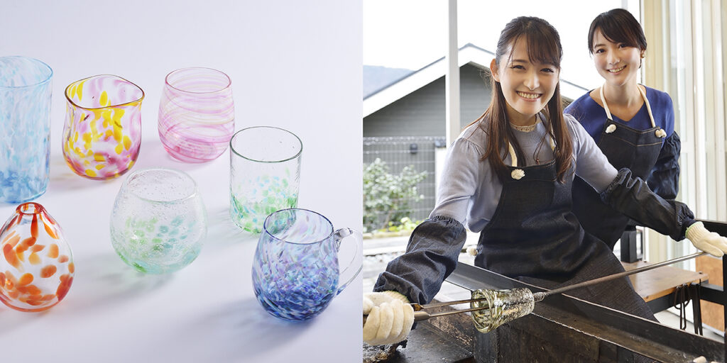 Colourful hand-blown glass cups beside two people shaping molten glass in a workshop
