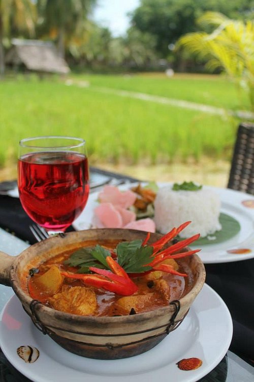 Claypot curry, rice and a pink drink at a restaurant overlooking Langkawi's paddy fields