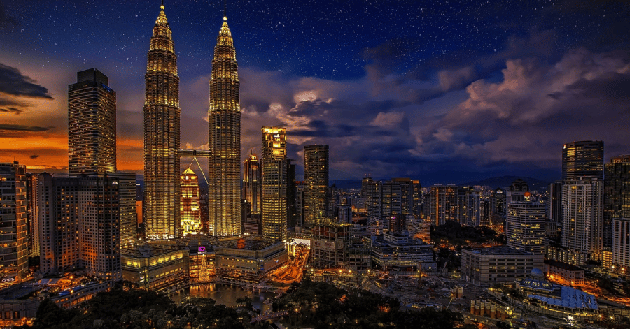 Kuala Lumpur skyline at night with the lit Petronas Twin Towers