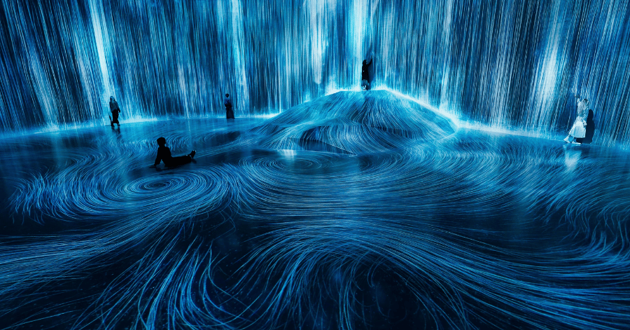 Visitors stepping between glowing coloured planks suspended in a dark teamLab room