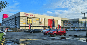 Exterior of AEON Mall Tebrau City with its red AEON sign above a car park