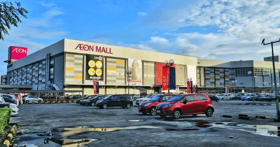 Exterior of AEON Mall Tebrau City with its red AEON sign above a car park