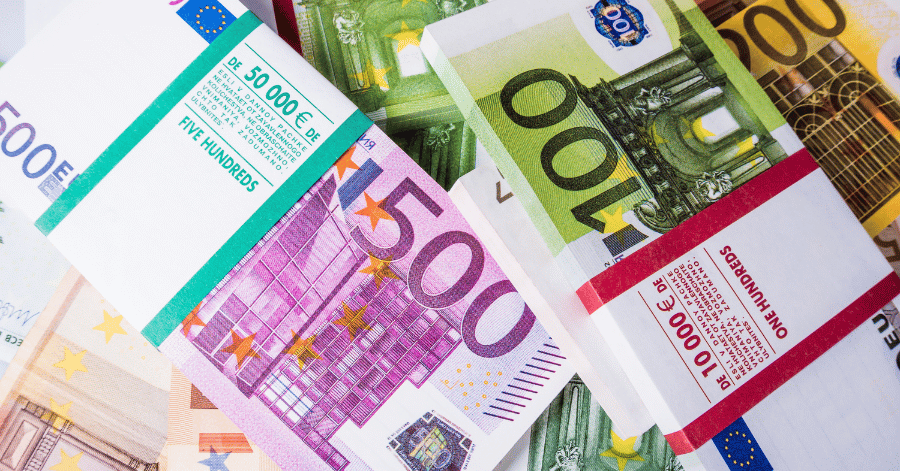 Wrapped bundles of 100, 200 and 500 euro banknotes stacked together