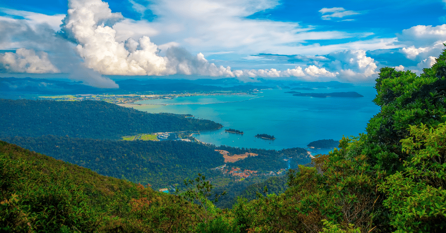Aerial view over Langkawi's forested hills, marina and island-dotted turquoise bay