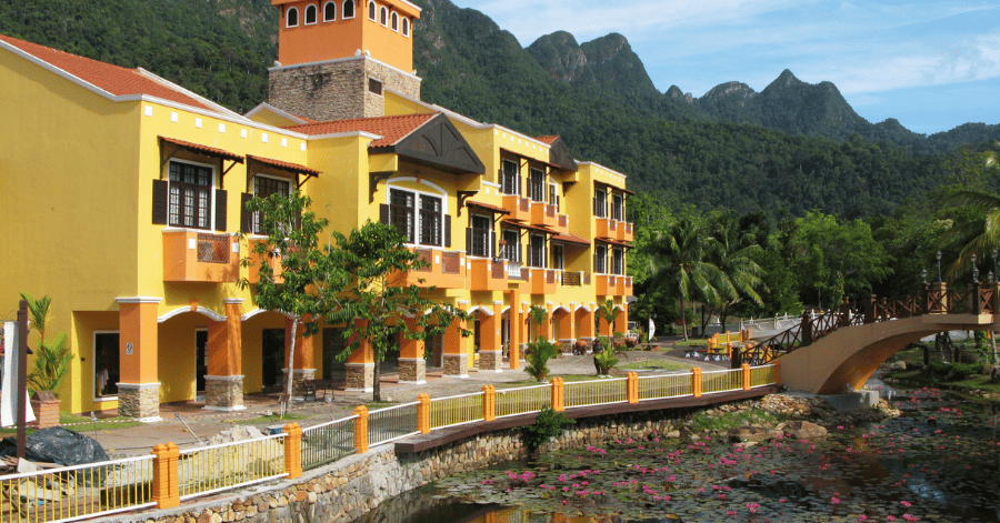 Oriental Village's yellow Mediterranean-style buildings and lily pond below Machinchang mountain