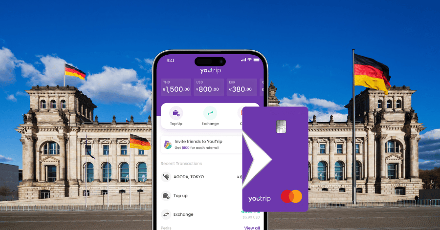 The purple YouTrip Mastercard and app showing multi-currency balances in front of the Reichstag
