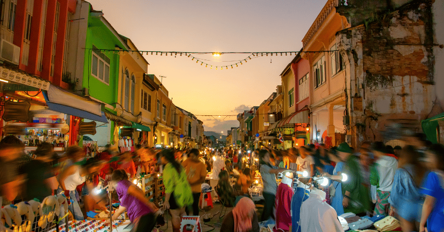 Crowds at a Phuket Old Town night market lined with lit Sino-Portuguese shophouses